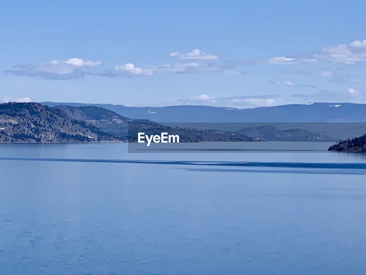 Scenic view of sea against blue sky