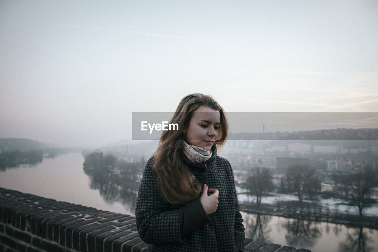 Teenage girl with eyes closed against sky