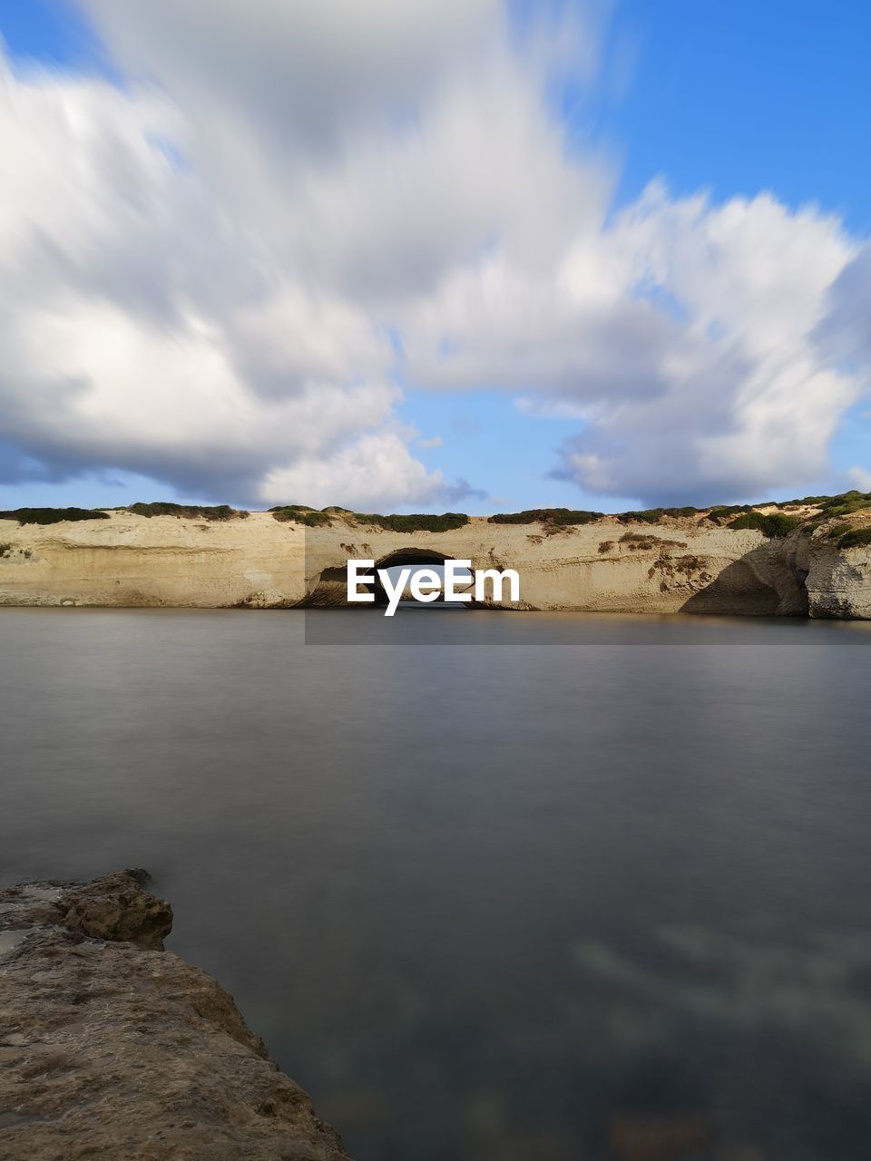 sea, water, reflection, coast, sky, cloud, shore, landscape, horizon, nature, rock, scenics - nature, ocean, no people, beauty in nature, environment, land, morning, tranquility, travel destinations, sunlight, bay, day, body of water, tranquil scene, outdoors, architecture, travel, blue, mountain, dusk, cliff, terrain, non-urban scene, wave, built structure