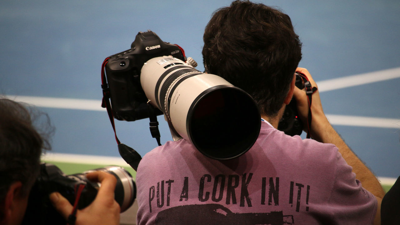 CLOSE-UP OF MAN PHOTOGRAPHING CAMERA ON THE MIRROR