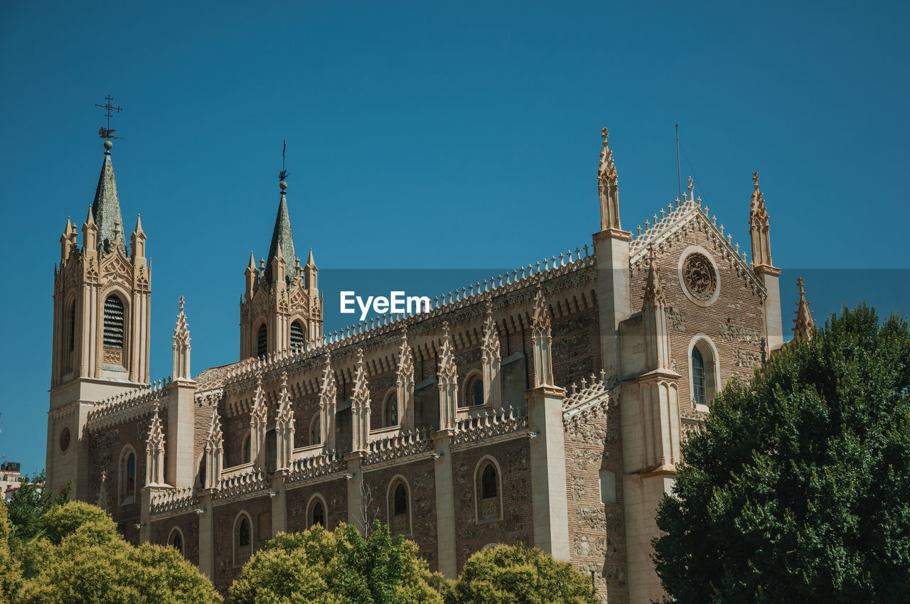 Facade of the san jeronimo el real cathedral in gothic style in a sunny day at madrid, spain.