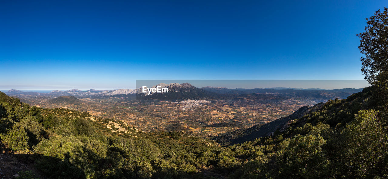 Scenic view of mountains against clear blue sky