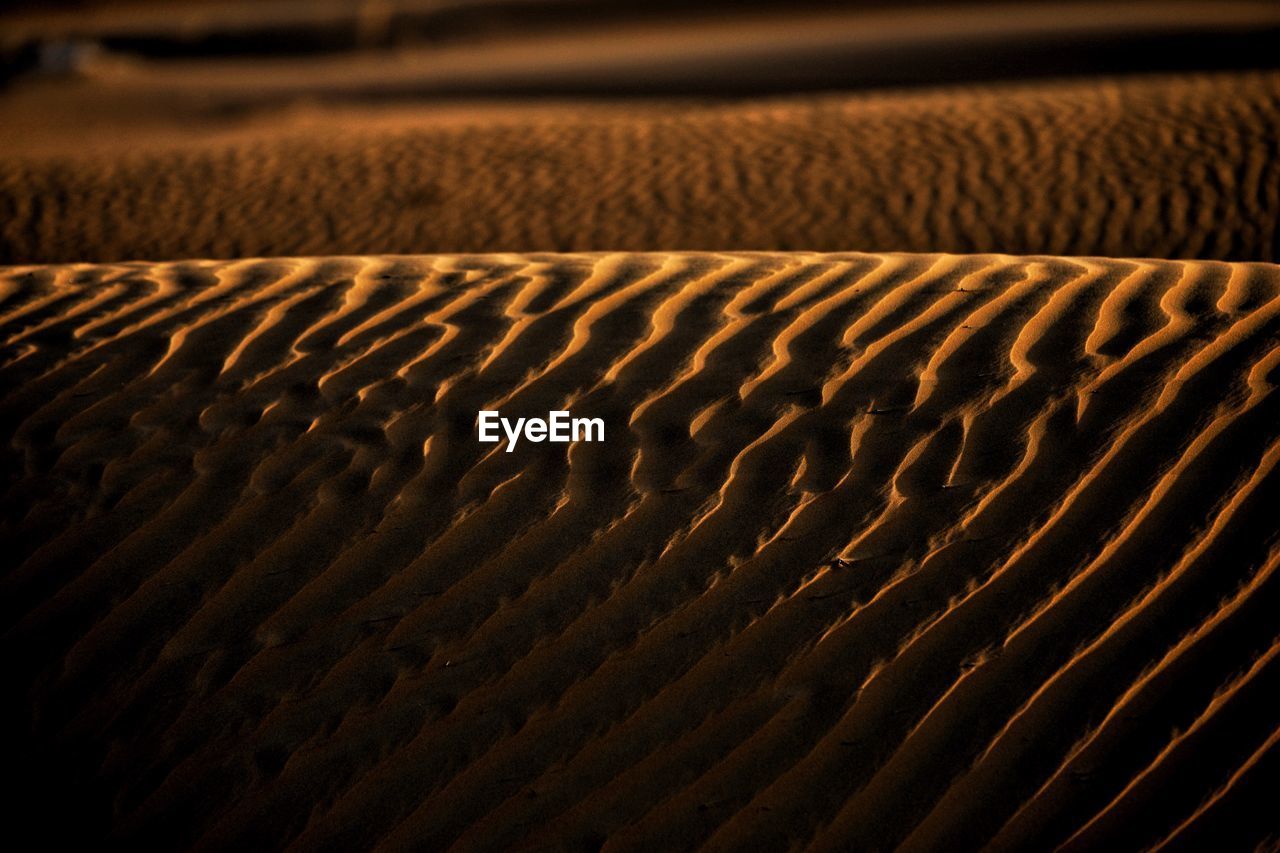 Full frame shot of sand dunes at sunset