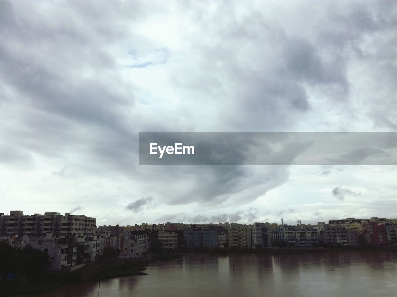 VIEW OF RIVER AGAINST CLOUDY SKY