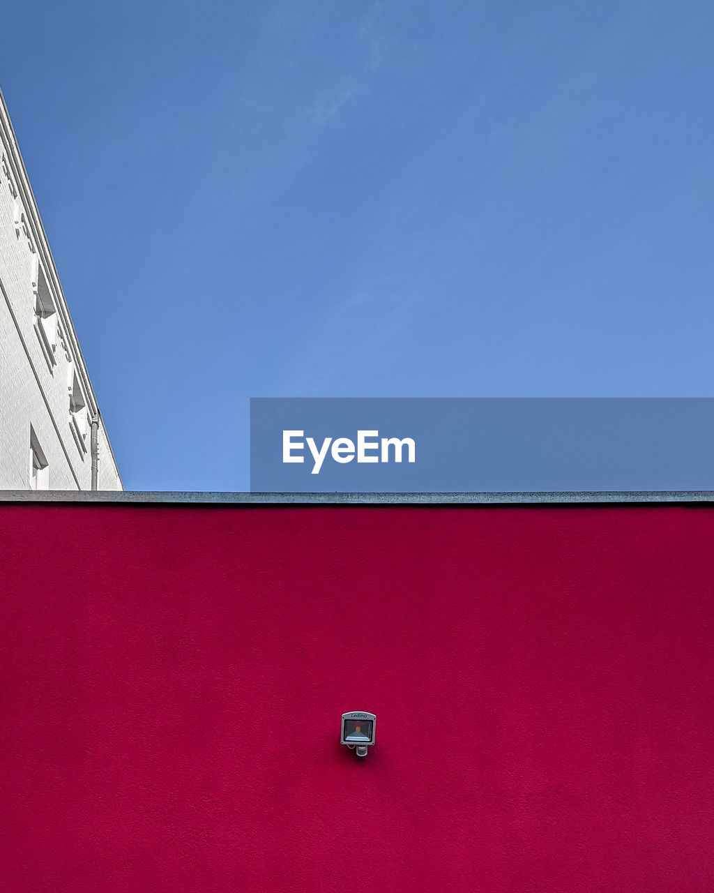 Low angle view of red building against blue sky