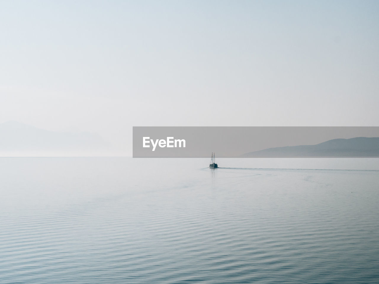 Scenic view of calm sea against clear sky