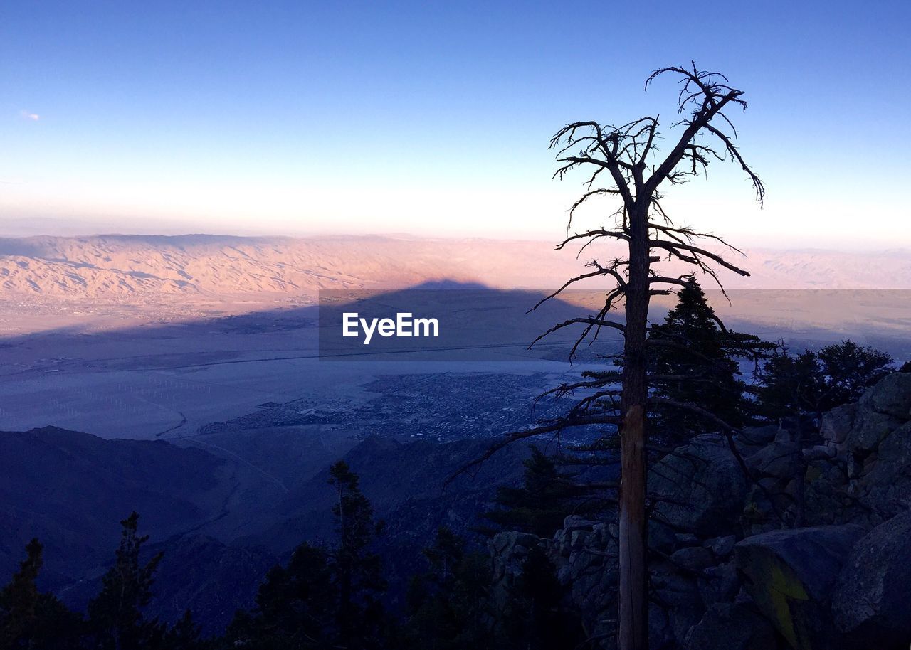 Scenic view of landscape against sky at sunset