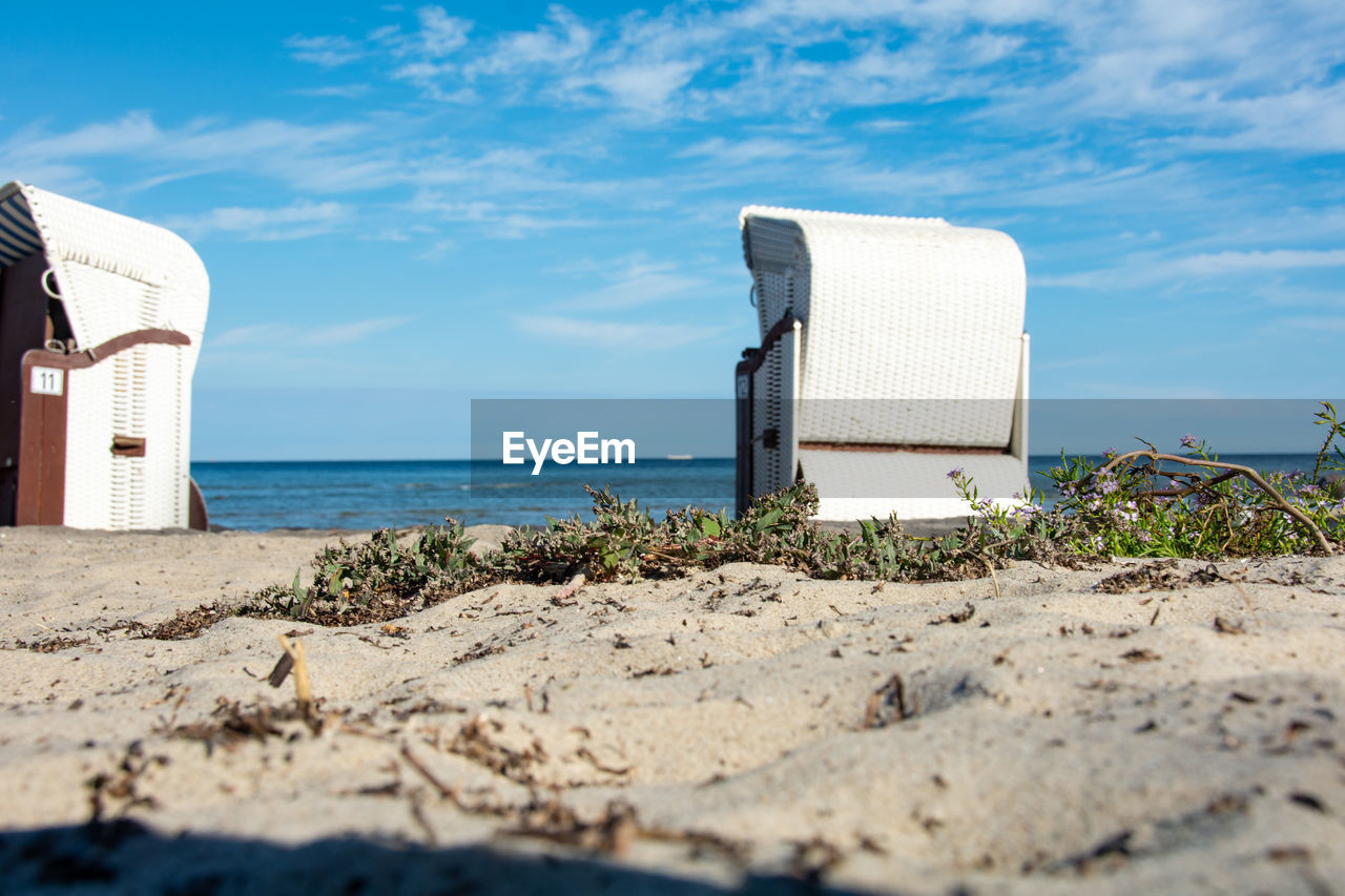 beach, sky, sea, land, water, coast, nature, vacation, shore, ocean, sand, cloud, architecture, no people, holiday, scenics - nature, travel destinations, trip, travel, day, built structure, horizon over water, horizon, blue, sunlight, hut, outdoors, summer, tranquility, beauty in nature, tourism, tranquil scene, coastline, body of water, building exterior