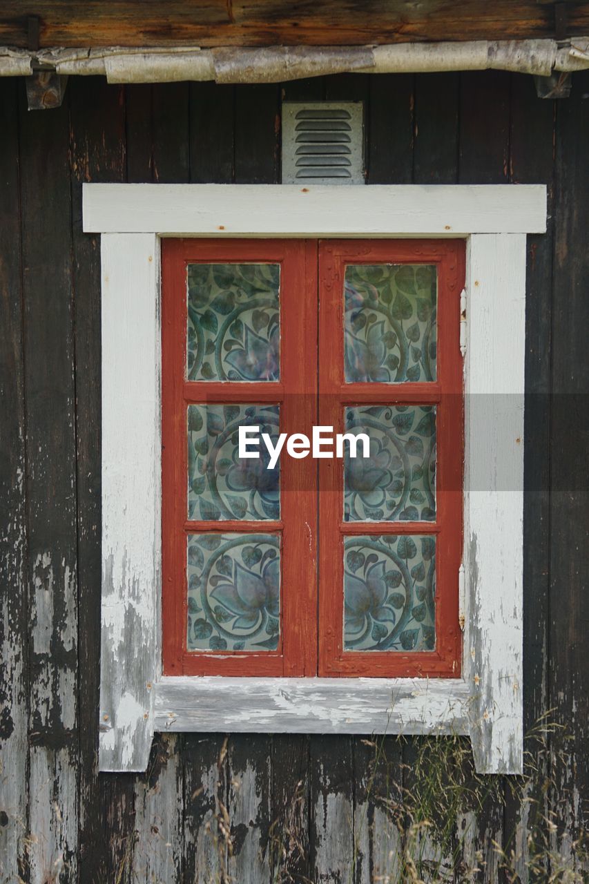 Closed window of old wooden building