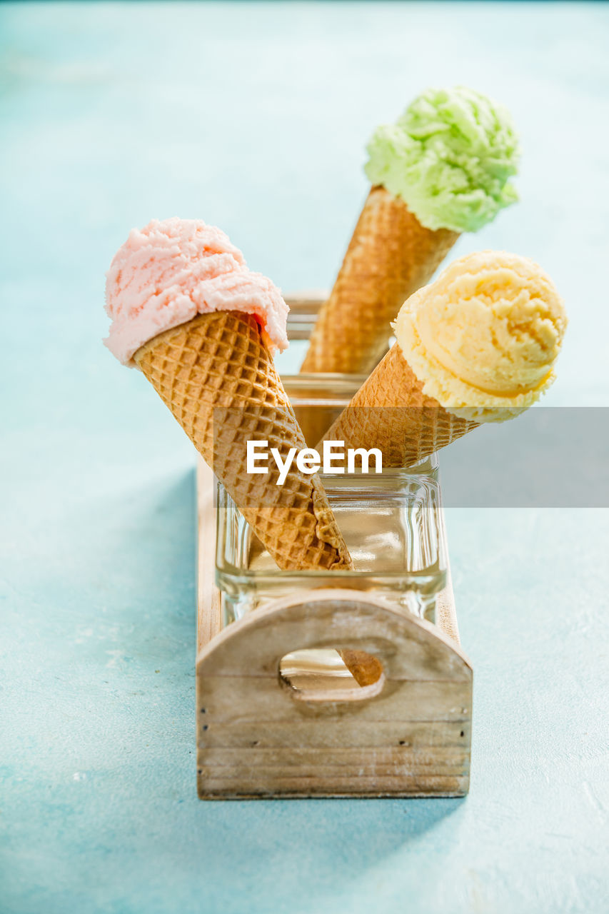 Close-up of ice cream cones in containers on table