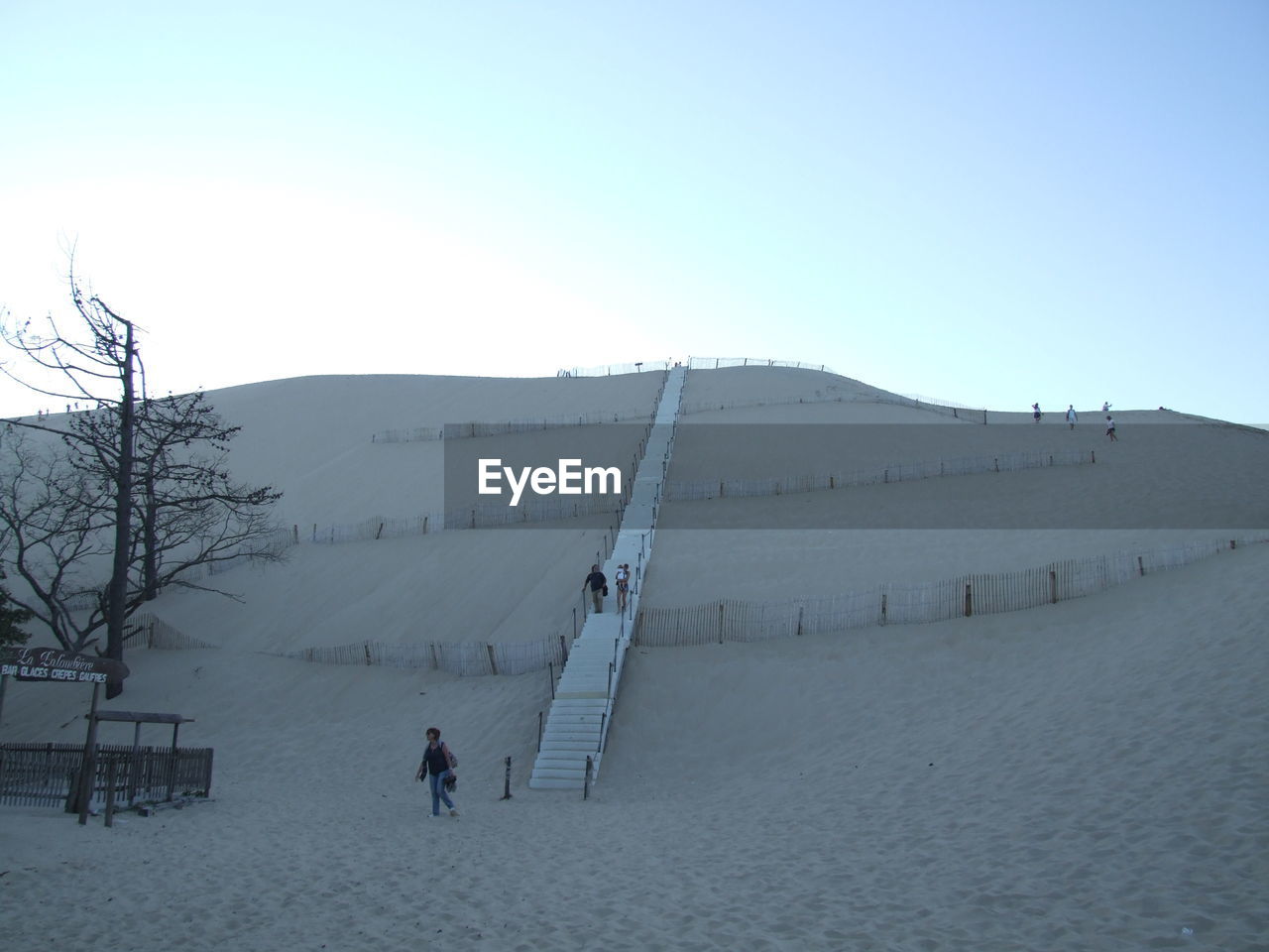 PEOPLE WALKING ON SNOW COVERED LANDSCAPE