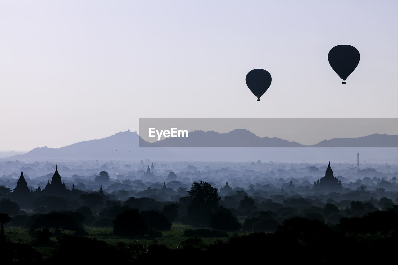 SILHOUETTE OF HOT AIR BALLOON IN SKY