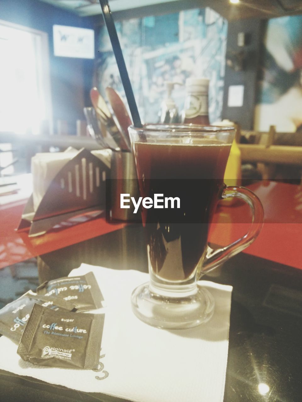 CLOSE-UP OF DRINK IN GLASS ON TABLE