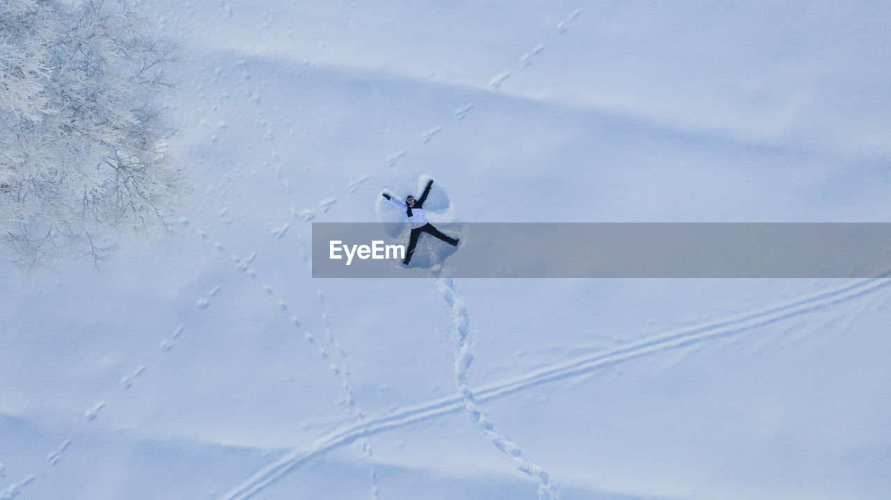 Person making snow angel