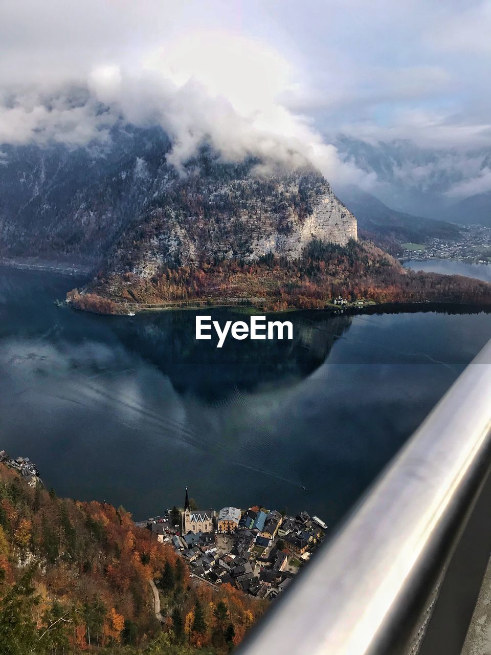 Aerial view of sea by mountains against sky