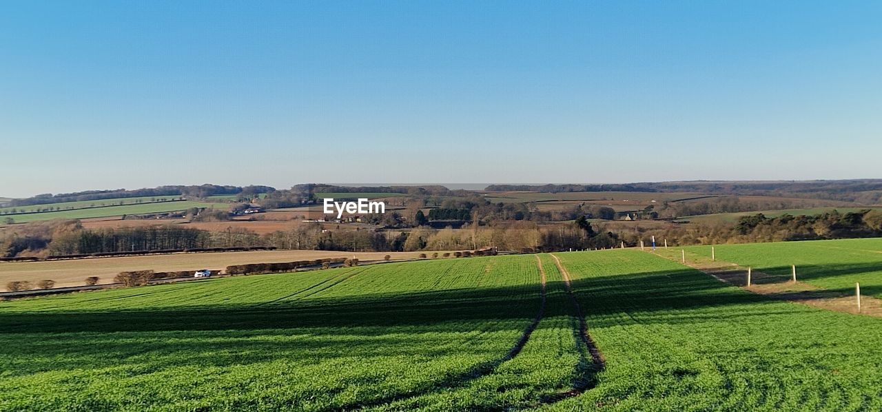 reflection, water, plant, nature, green, agriculture, rural scene, landscape, scenics - nature, no people, beauty in nature, tranquility, field, day, reservoir, environment, land, tranquil scene, growth, farm, grass, tree, outdoors, aerial photography, hill, river, crop, idyllic, blue, non-urban scene, sky