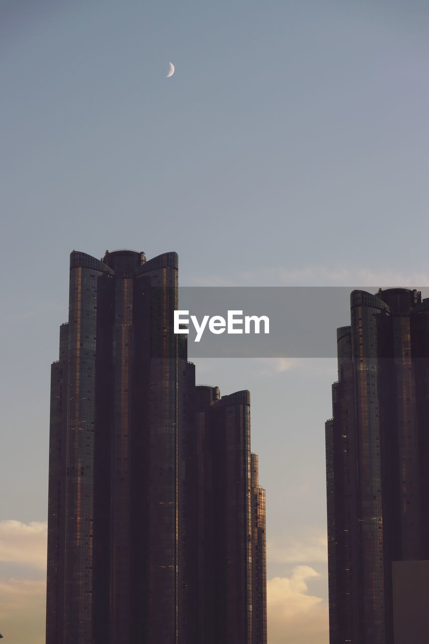 sky, building exterior, architecture, moon, city, built structure, skyline, skyscraper, building, office building exterior, nature, landscape, horizon, urban skyline, no people, cityscape, evening, sunset, dusk, residential district, cloud, outdoors, night, travel destinations, reflection, tower block