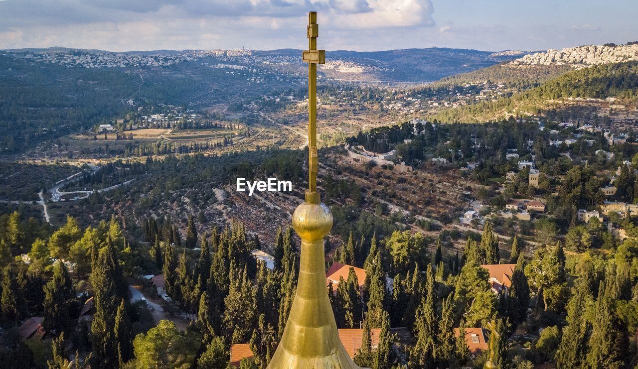 View of religious cross against scenery