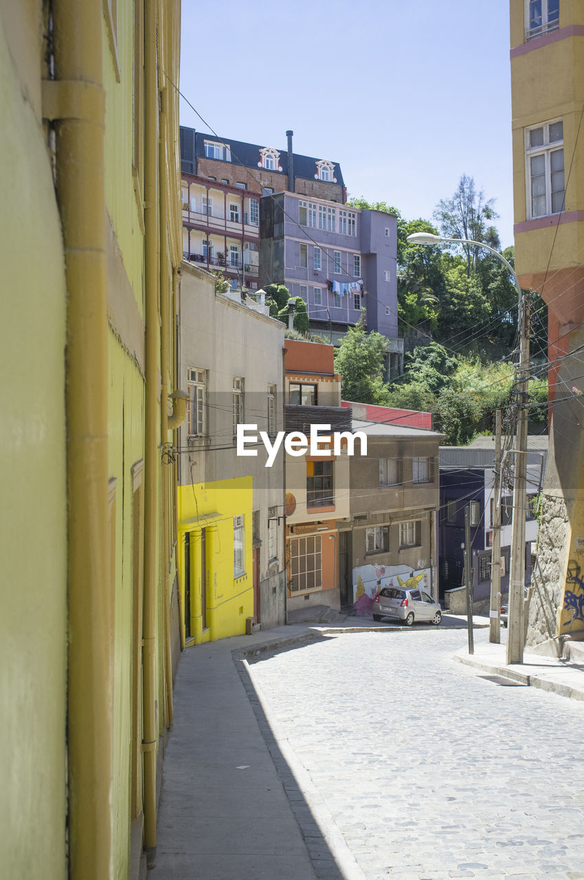 Street amidst buildings against clear sky