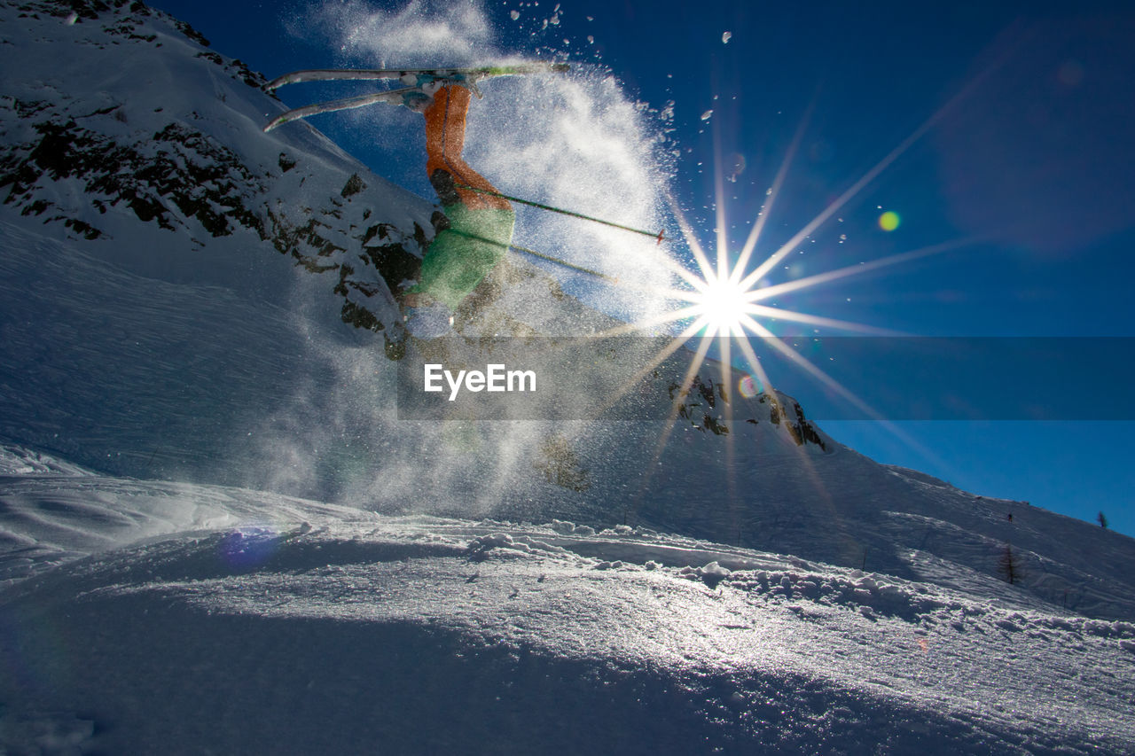 Low angle view of skiing on snow landscape