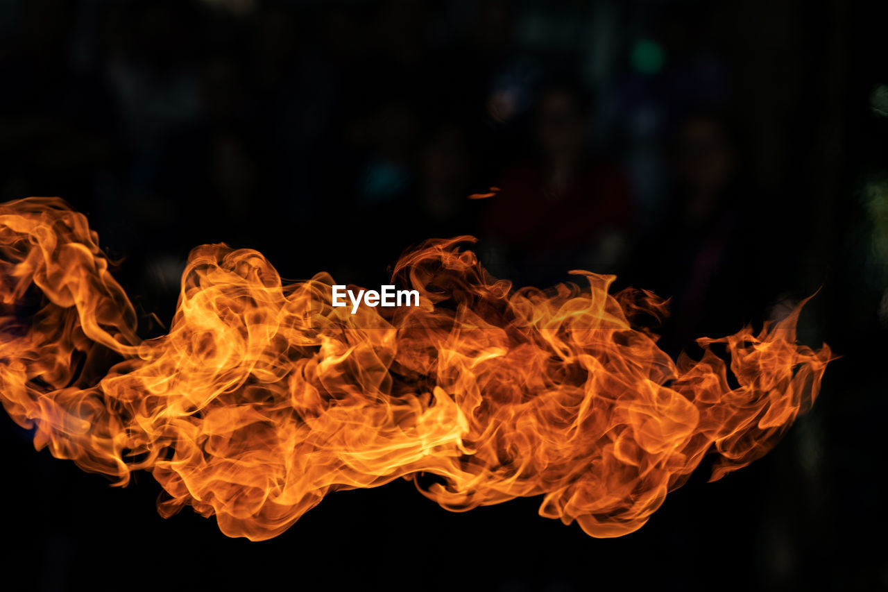 CLOSE-UP OF BURNING FIRE AGAINST BLACK BACKGROUND