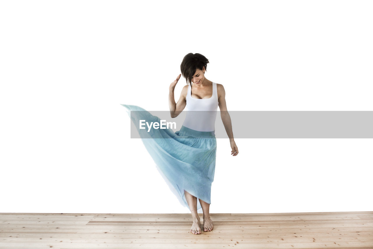 Full length of woman standing against white background
