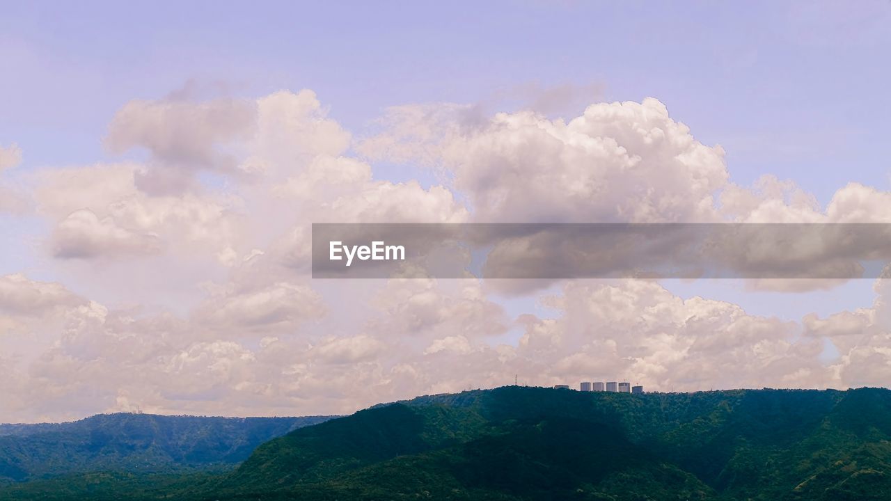 SCENIC VIEW OF MOUNTAINS AGAINST CLOUDY SKY