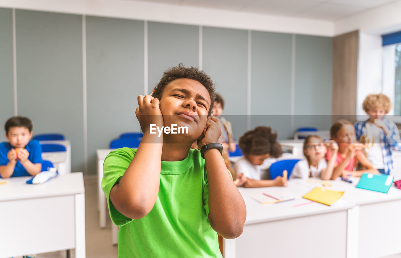 Girl gesturing at classroom