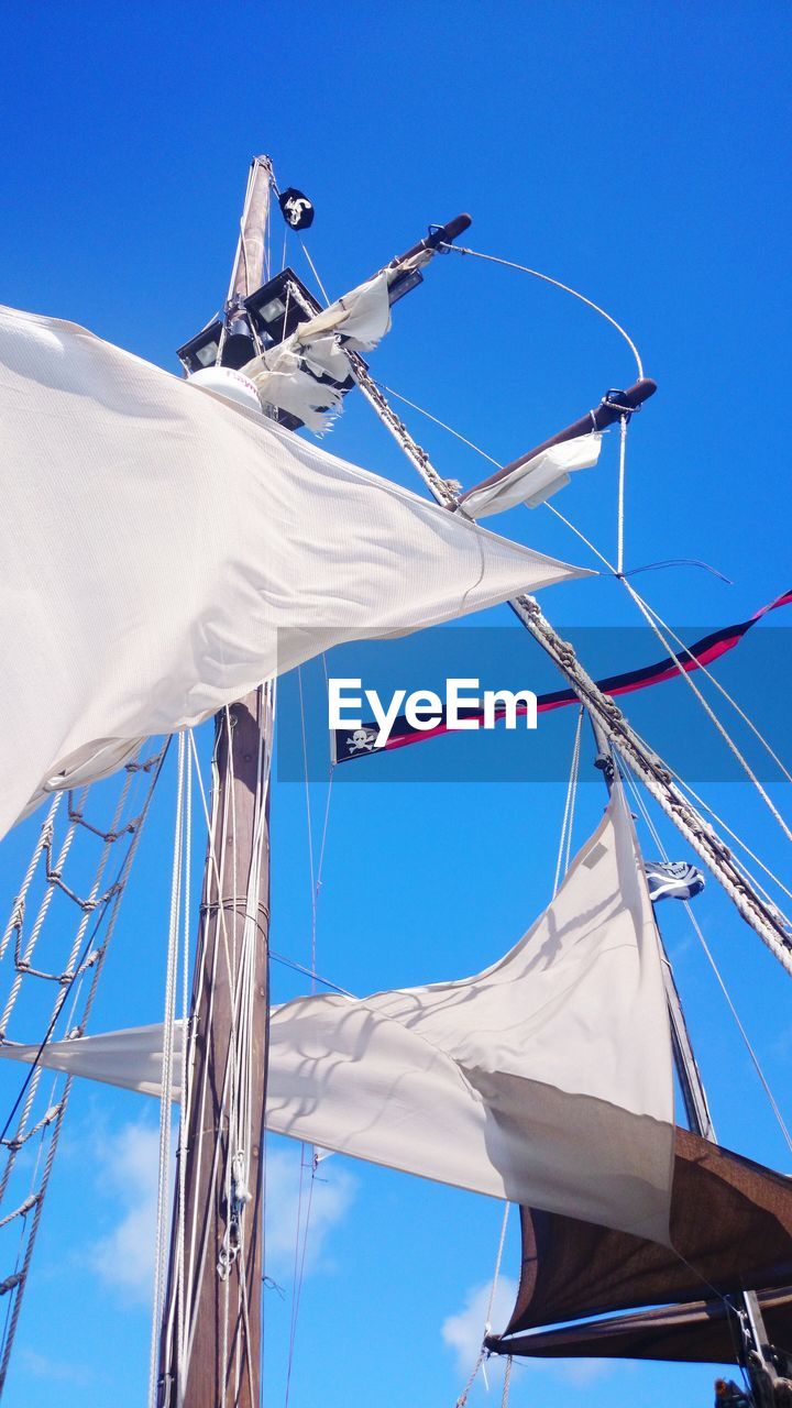 LOW ANGLE VIEW OF SAILBOAT ON BLUE SKY