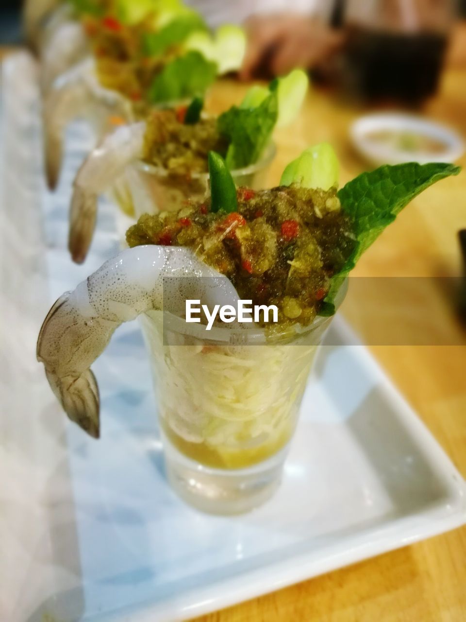 High angle close-up of drinks served in plate on table