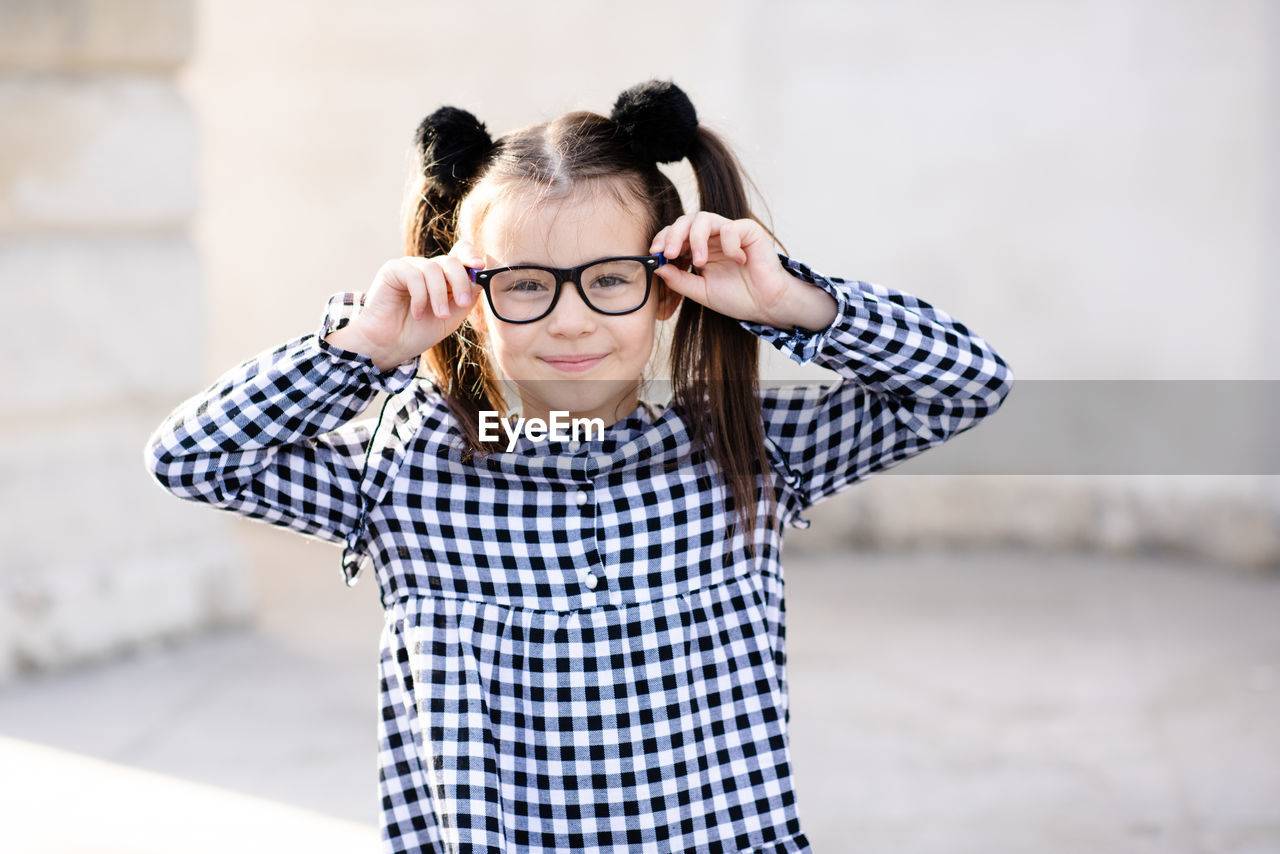 Cute little pupil girl 5-6 year old wear glasses and casual stylish dress. back to school. childhood