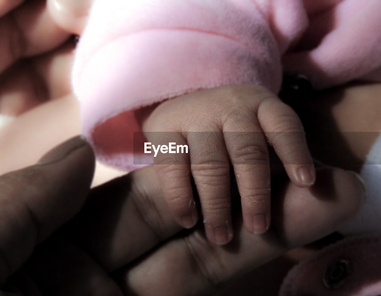 CLOSE-UP OF MOTHER HOLDING BABY