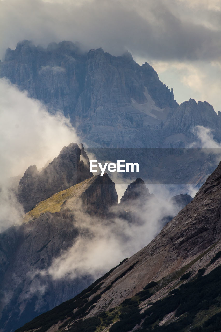 Scenic view of mountains against cloudy sky