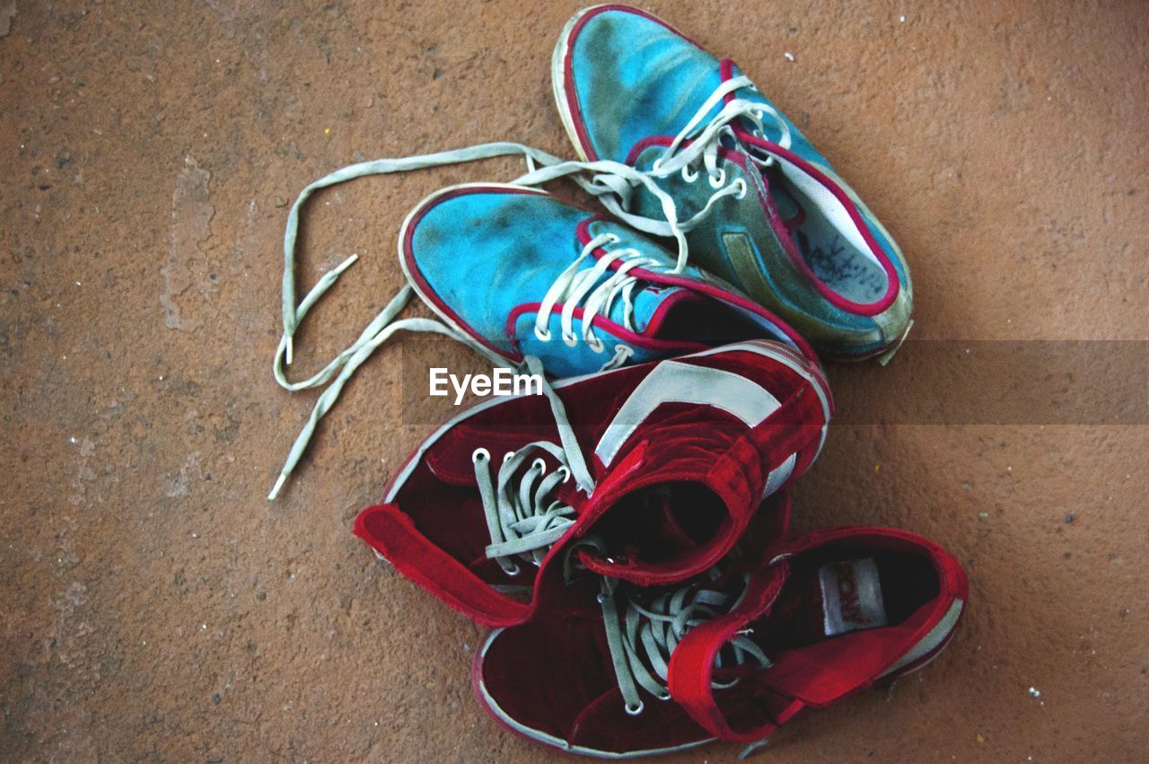 HIGH ANGLE VIEW OF SHOES ON WOODEN TABLE