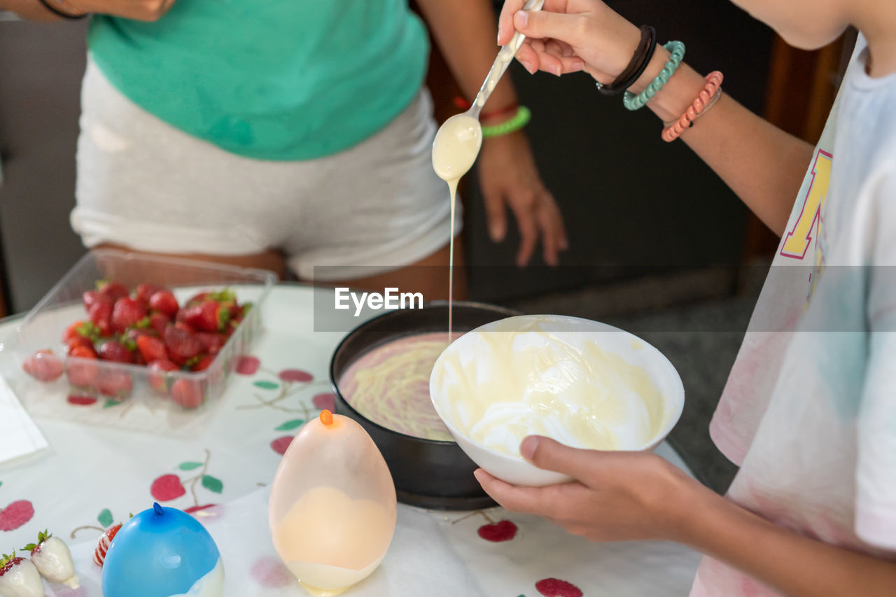 HIGH ANGLE VIEW OF PEOPLE HOLDING FOOD