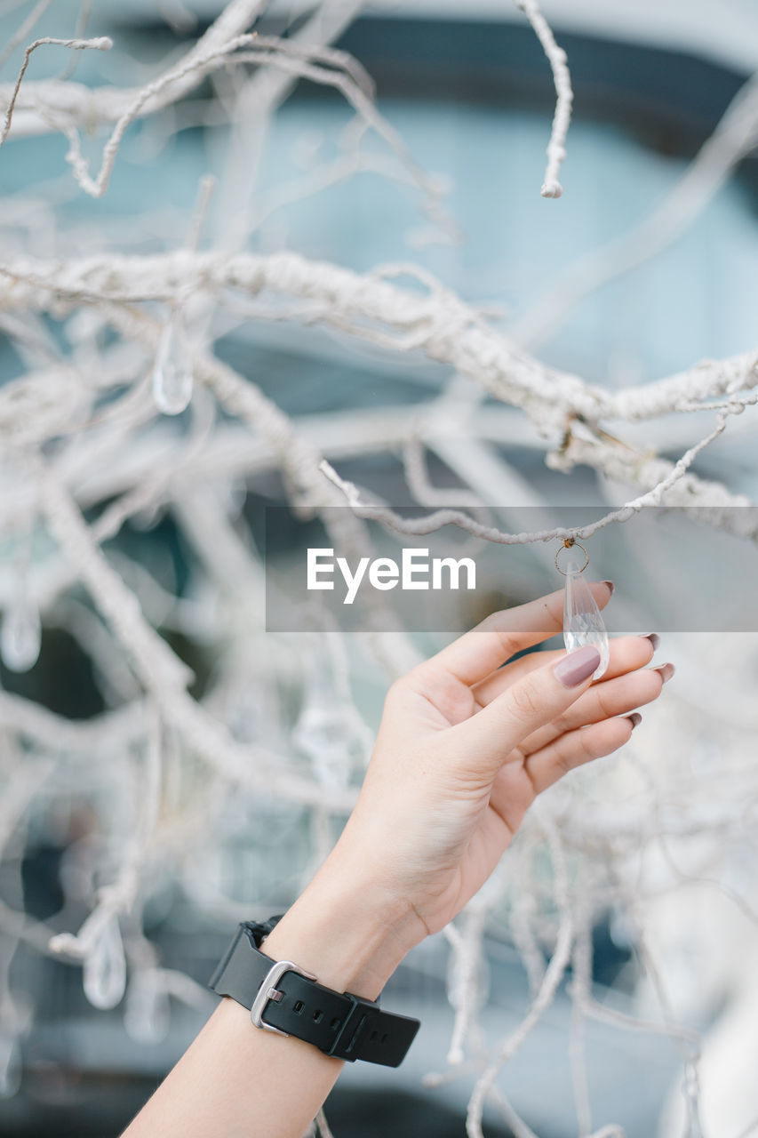 Cropped hand of woman holding decoration