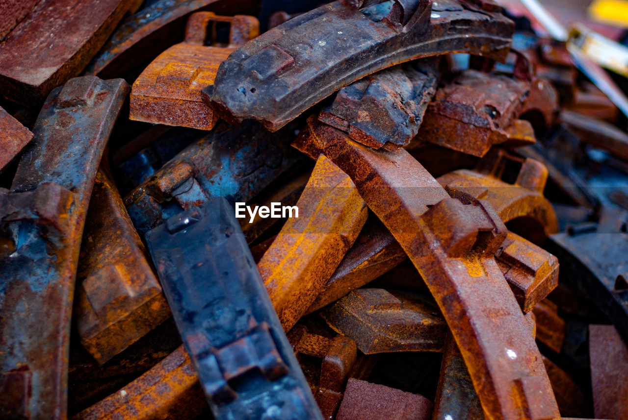 iron, rusty, metal, scrap, wood, no people, damaged, abandoned, old, rundown, decline, deterioration, day, large group of objects, close-up, transportation, weathered, backgrounds, outdoors