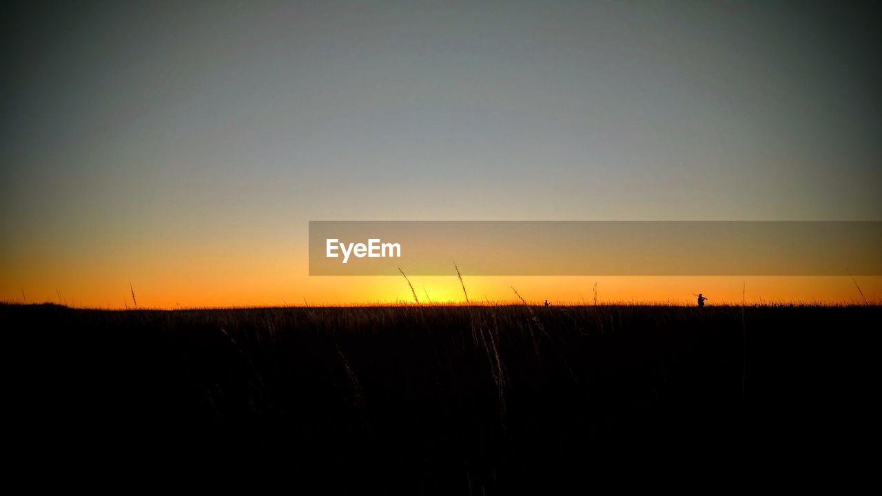 SILHOUETTE LANDSCAPE AGAINST SKY DURING SUNSET