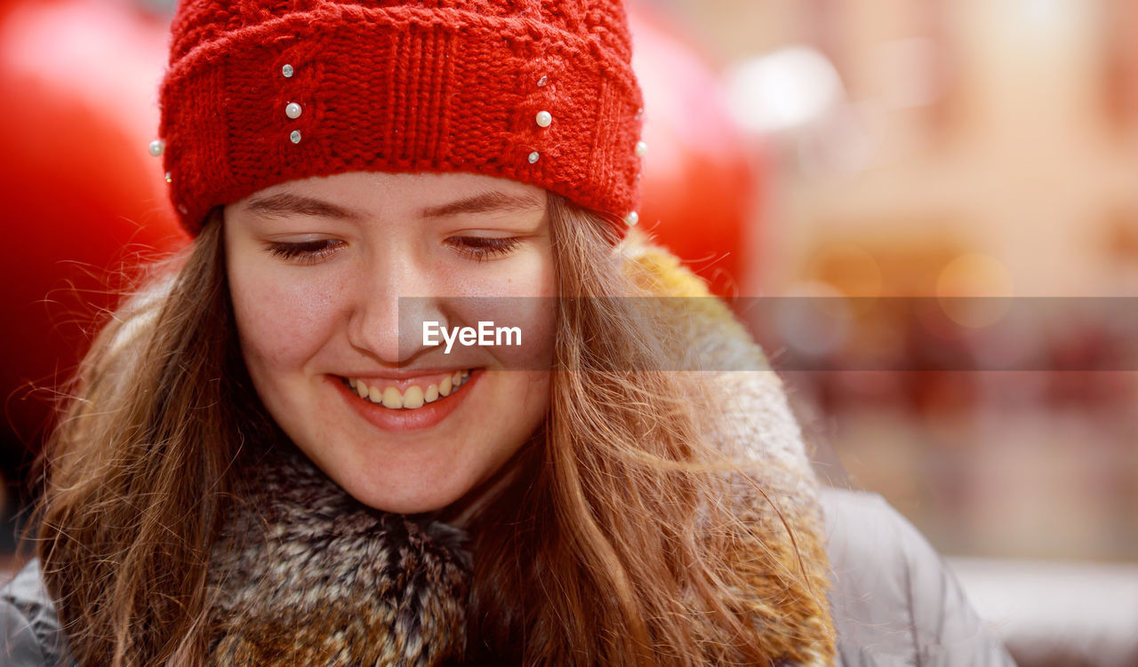 Close-up of smiling girl during winter