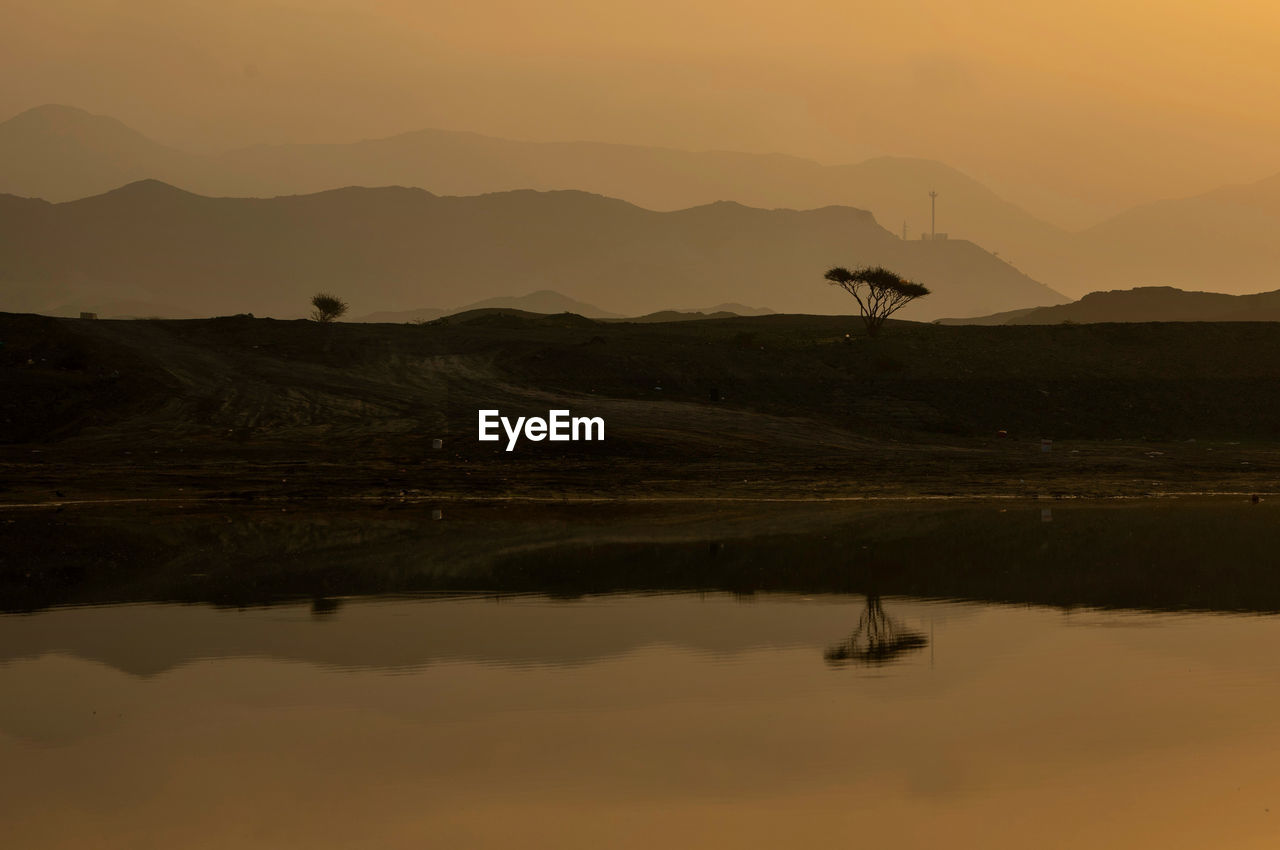 Scenic view of lake against sky during sunset