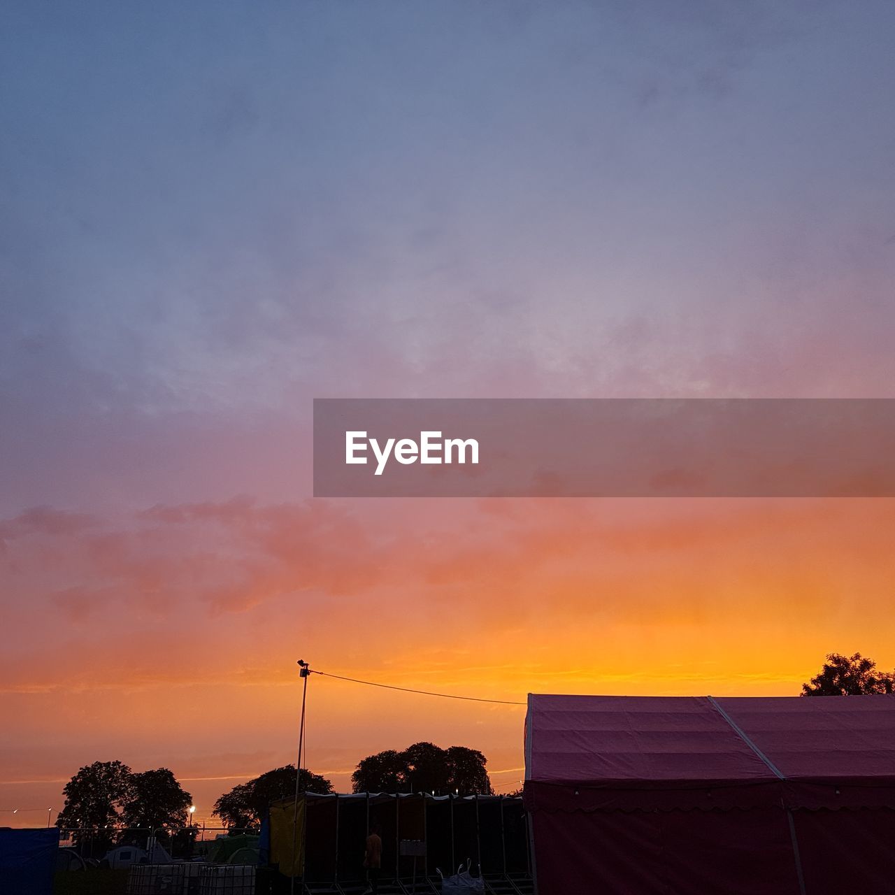 SILHOUETTE BUILDINGS AGAINST ORANGE SKY