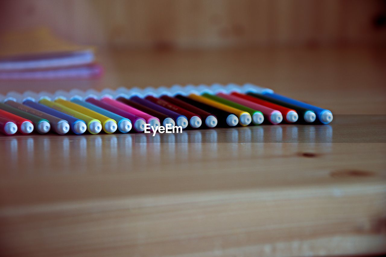 Close-up of multi colored pencils on table