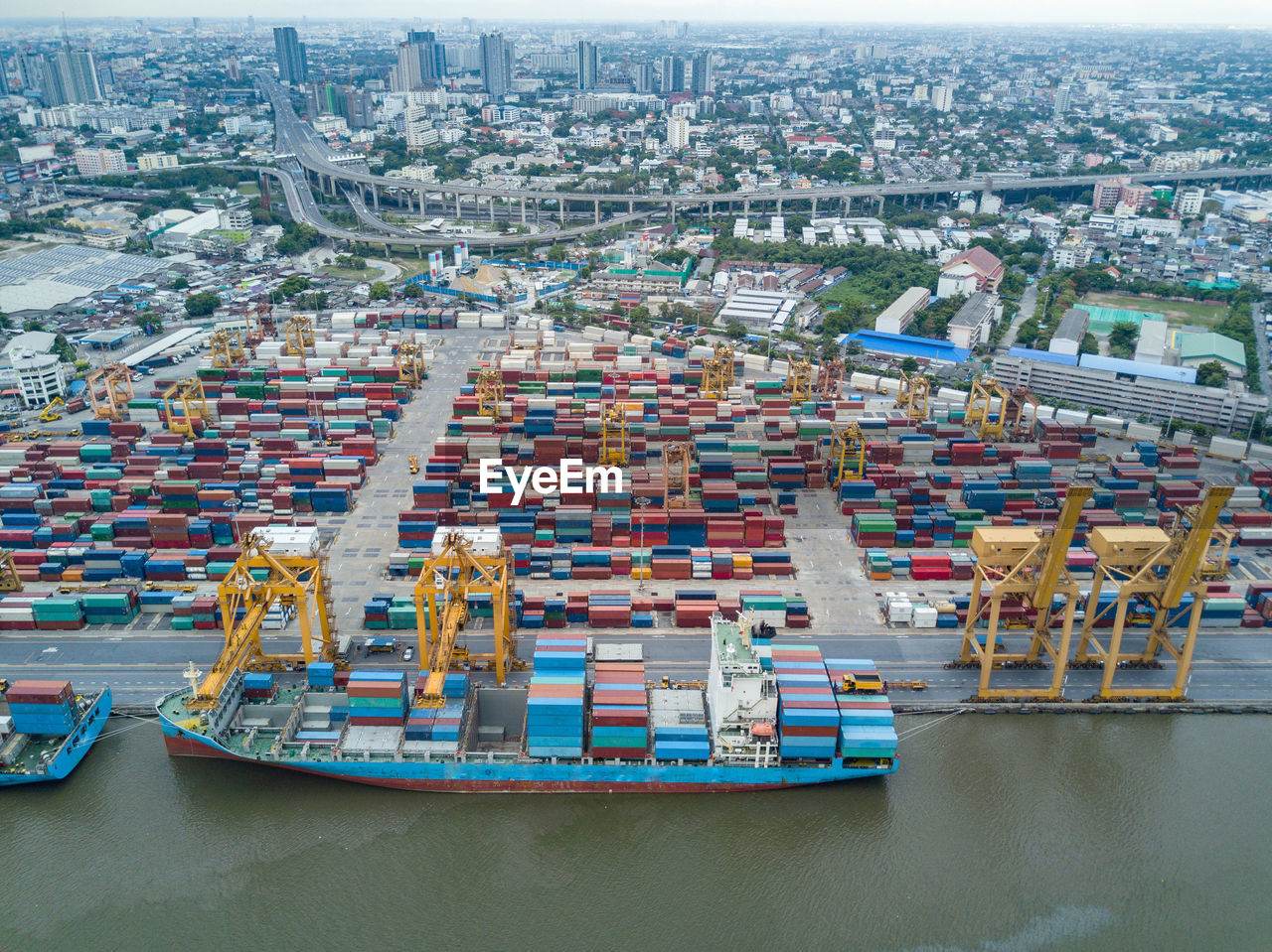 HIGH ANGLE VIEW OF COMMERCIAL DOCK AND CITY