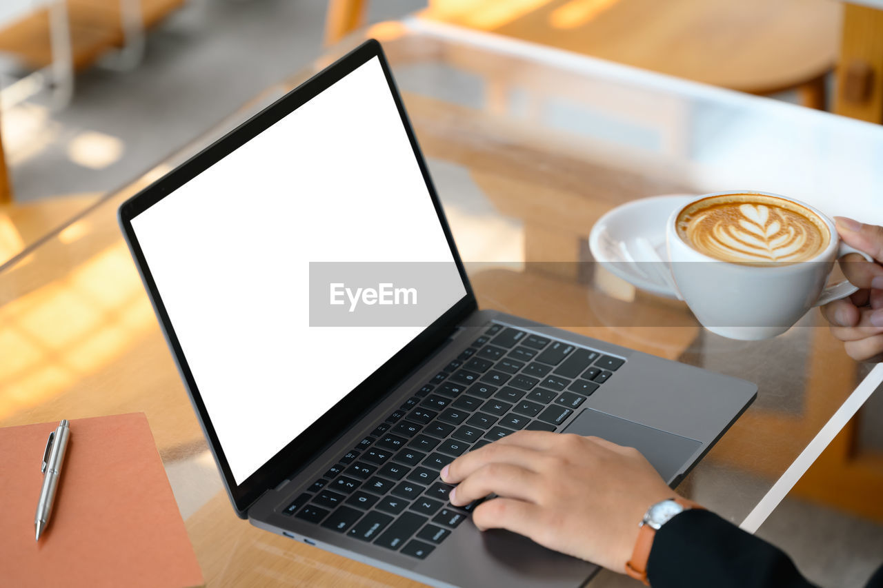 high angle view of laptop and coffee on table