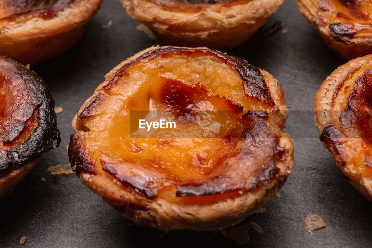 Close up of portuguese 'pasteis de nata', custard tart on a dark background