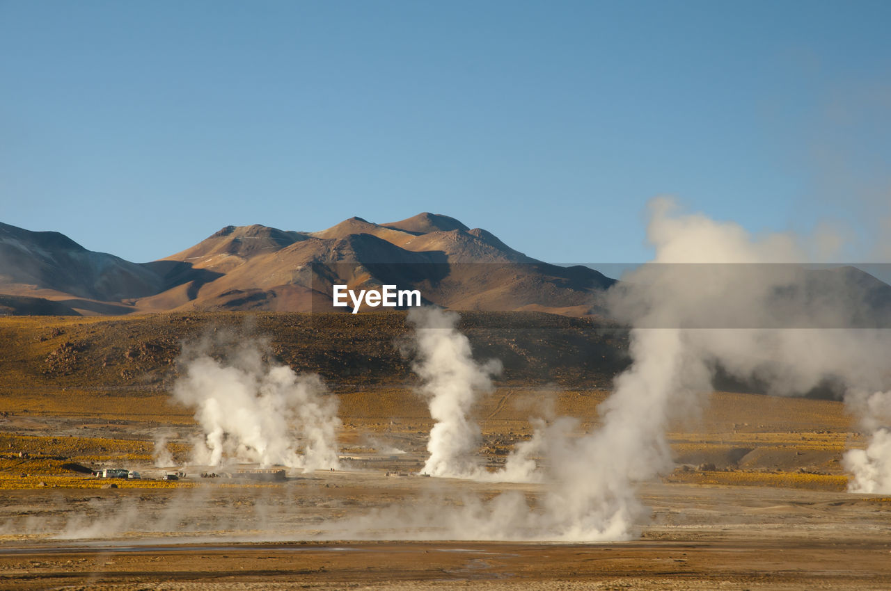 Smoke emitting from volcanic mountain against sky