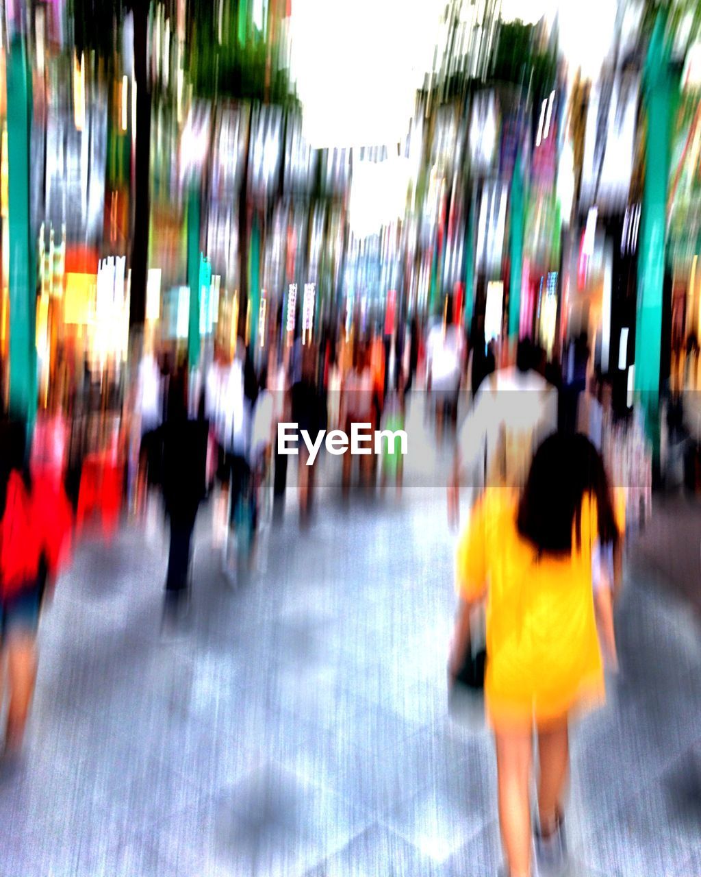 BLURRED MOTION OF CROWD WALKING ON CITY