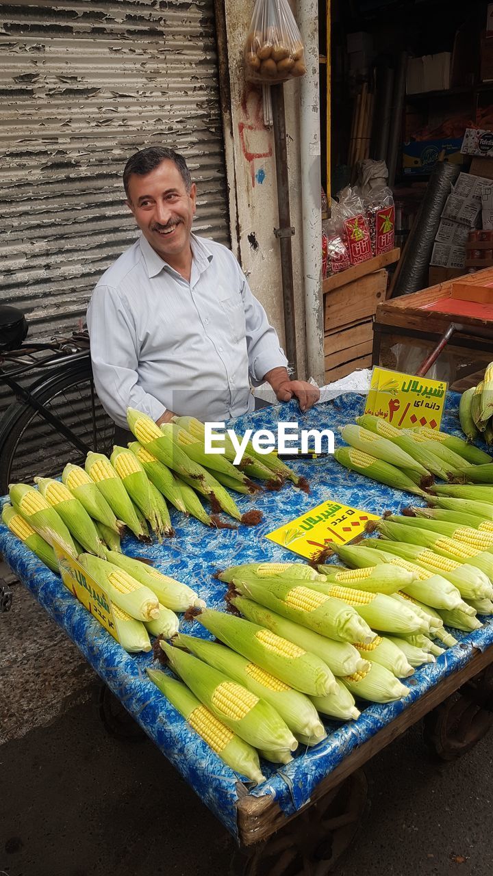 Portrait of a smiley merchant in market stall