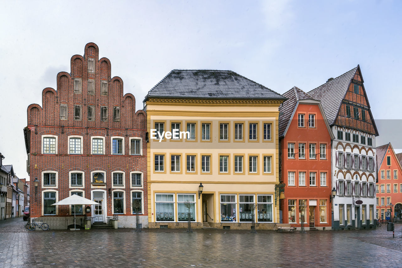 RESIDENTIAL BUILDING BY RIVER AGAINST SKY