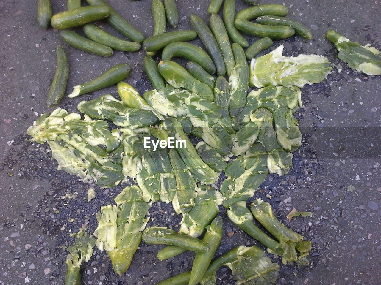 Directly above view of mashed fresh cucumbers on street